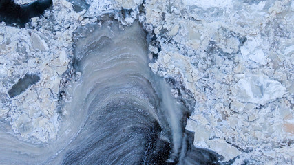 aerial frozen water in the river sea lake top view, ice hummocks, ice freezing