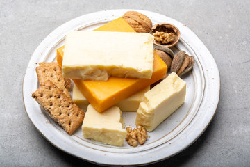 Cheese collection, matured and orange original British cheddar cheese in blocks served with crackers