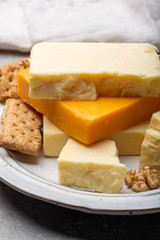 Cheese collection, matured and orange original British cheddar cheese in blocks served with crackers