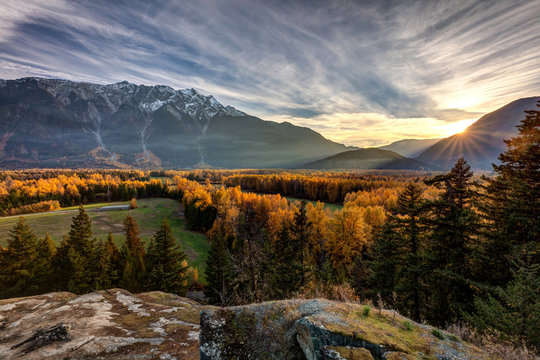 The sunshine giving a golden glow to the trees in Autumn with Mount Currie towering over the Pemberton Valley in British Columbia, Canada