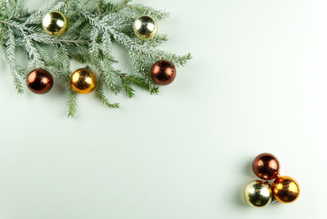 fir branches with cones and Christmas toys on a white wooden background. Copy Space