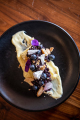 Lemon Cake with Blueberries and Glaze Close-up on a White Plate