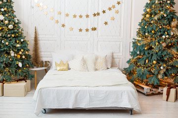 Romantic bedroom in light colors with a lot of garland lights decorated for New Year Celebrating....