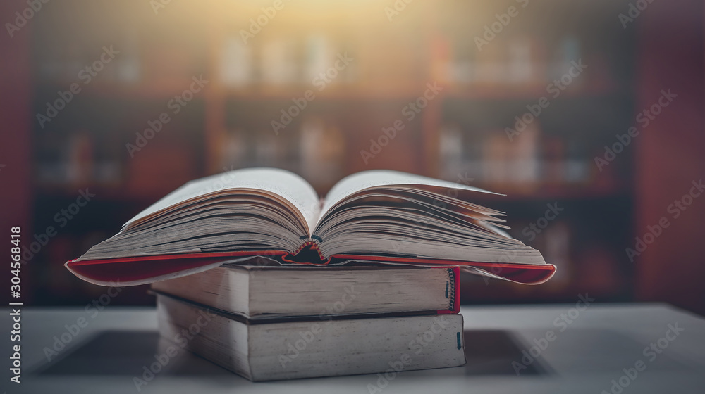 Poster stack of books in the library and blur bookshelf background