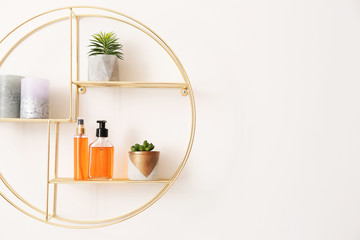 Shelf with decor hanging on light wall