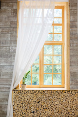 large window with wood trim wit white tule. Beautiful morning