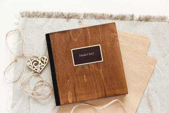 family album with wooden cover. Book with inscription "family day" 