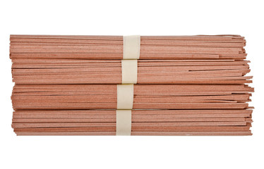 Dried raw japanese soba noodle sticks isolated on white background. Top view.