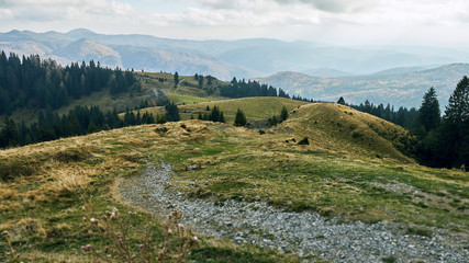Naklejka premium Dust road and hills