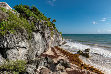 Beautiful beach in Tulum Mexico, Mayan ruins on top of the cliff.