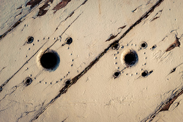 two holes on wooden background