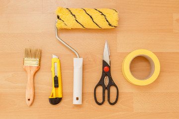 Tools for gluing wallpapers on the laminate floor. A room after renovation. Fresh repair in a room.