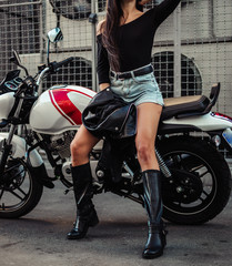 Obraz na płótnie Canvas Pretty young sexy fashion model posing on the motorcycle.