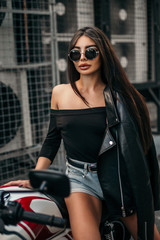 Naklejka na ściany i meble Pretty young sexy fashion model posing on the motorcycle.