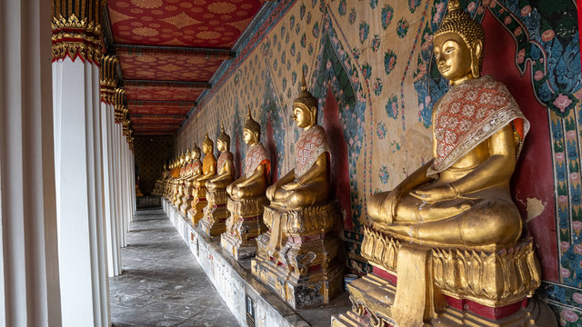 Several Buddha images lined up in Phra Kaew Temple, Bangkok, Thailand