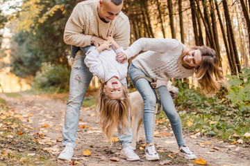 Fototapeta premium Happy family is having fun walking in the park.