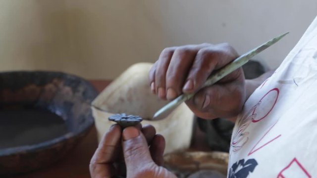 A woman makes pottery pieces