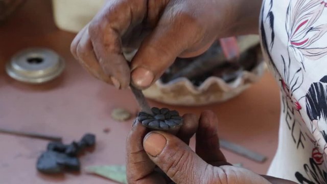 A woman makes pottery pieces