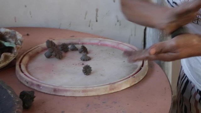 A woman makes pottery pieces