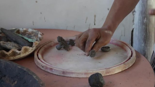 A woman makes pottery pieces