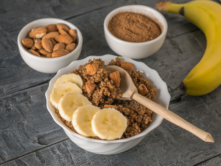 Banana with quinoa porridge with cocoa on a wooden table.