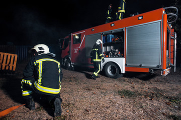 Firemen suppressing fire