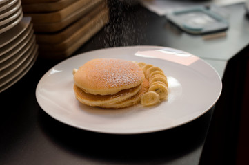 pancakes with banana on white dish