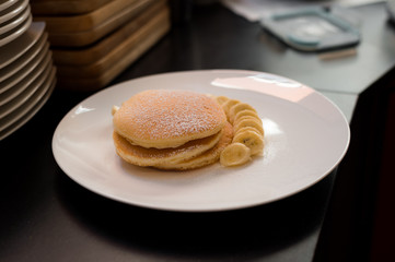 pancakes with banana on white dish