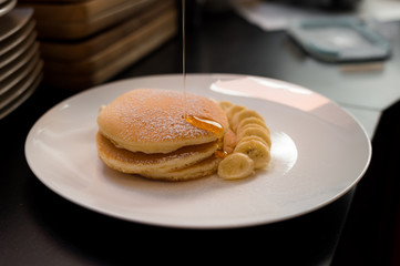 pancakes with banana on white dish