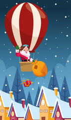 santa claus in a hot air balloon throwing gift boxes over houses and winter night background