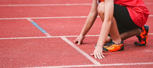 Cropped image of a sprinter getting ready to start at the stadium