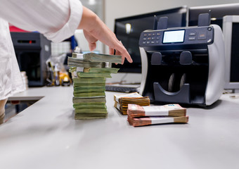 Counting person organizing bundles of euro € money