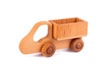 Close-up children's toy made of natural wood in the form of a dump truck  on a white isolated background. Studio photography. Eco-friendly toy for parents and children