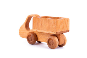 Close-up children's toy made of natural wood in the form of a dump truck  on a white isolated background. Studio photography. Eco-friendly toy for parents and children