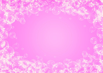 Soap bubbles frame on pink background with copy space