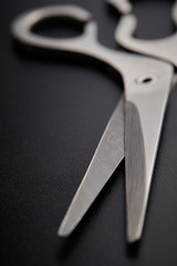 Stainless scissors on black background 