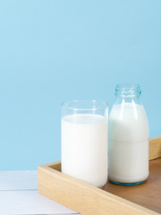 Milk bottle on table with blue background.