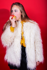 young pretty emitonal posing teenage girl on bright red background, happy smiling lifestyle people concept