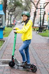 Young woman with helmet on an electric scooter in the city © Peruphotoart
