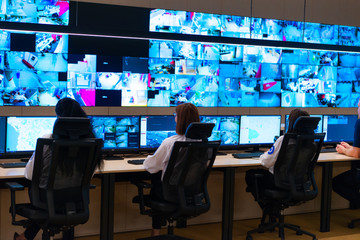 Team of secret agents in uniforms, monitoring cyber, video and communications at the main control...