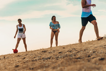 Friends playing on the sand beach