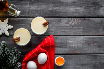 Make festive drink eggnog - ingredients on dark wooden background top view frame copy space