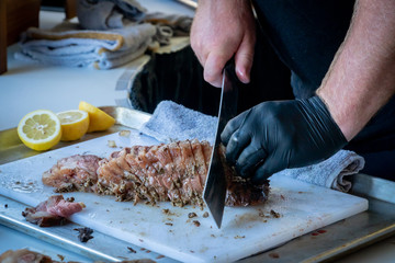 Close-up of chef cutting meat at an event in Southern Oregon