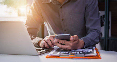 Businessman hand using smartphone, mobile p payments online shopping, omni channel, digital tablet in office.
