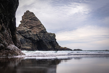 Rocks, sand, sea, and surf on a chilly fall day on the Oregon Coast