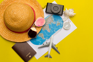 Flat lay traveler accessories on yellow background with blank space for text. Top view travel or...