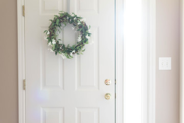 white front door with wreath sunshine
