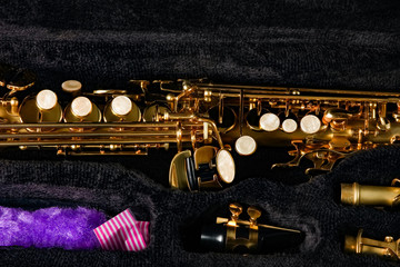 soprano saxophone in a case on a black background