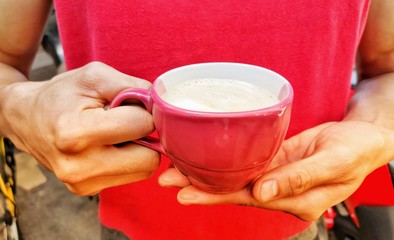 hands holding a cup of tea