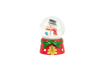 Crystal snow ball with Snowman inside and snow on red base on white background. Clipping path